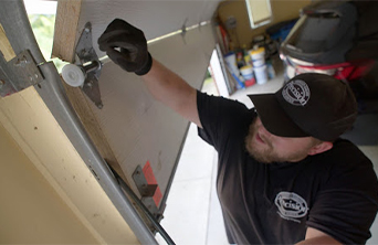 Technician Repairing Garage Door